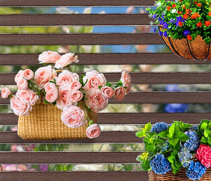 Brown slatted metal privacy screen with hanging baskets of roses and hydrangeas